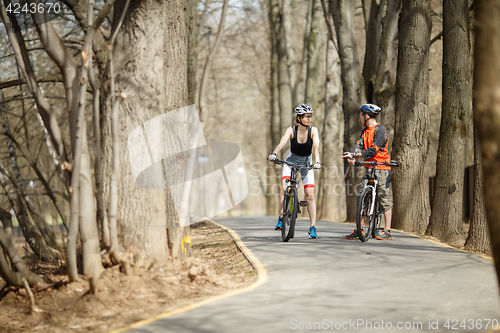 Image of Young cyclists drive around park