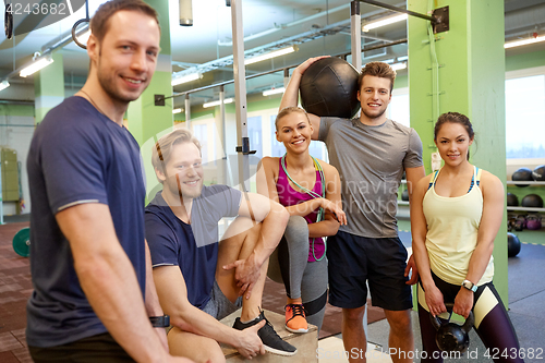 Image of group of friends with sports equipment in gym
