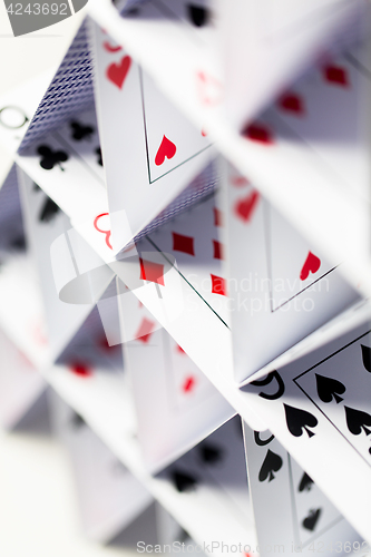 Image of house of playing cards over white background