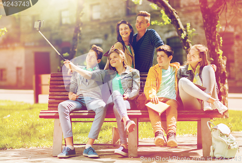 Image of happy teenage students taking selfie by smartphone