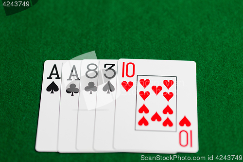 Image of poker hand of playing cards on green casino cloth