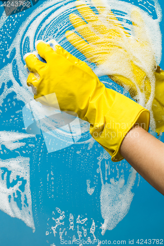 Image of Person washes with gloves window