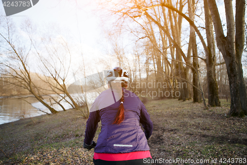 Image of Brunette in helmet rides bicycle