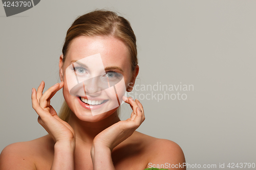 Image of Smiling model on gray background