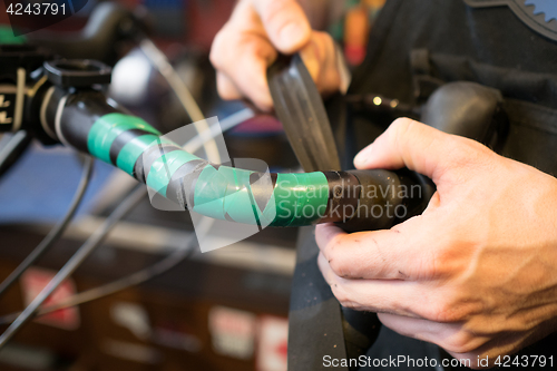 Image of Guy fixing rudder of bicycle