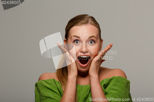 Image of Surprised girl in green jacket