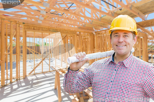 Image of Contractor With Plans On Site Inside New Home Construction Frami