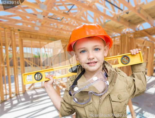 Image of Young Boy Contractor With Level On Site Inside New Home Construc