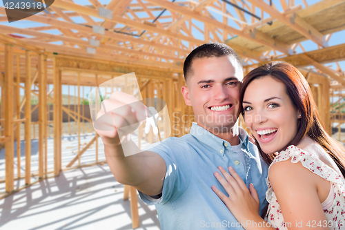 Image of Young Military Couple On Site With House Keys Inside Their New H