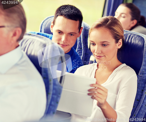 Image of happy couple with tablet pc in travel bus