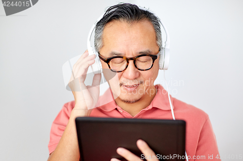 Image of man with tablet pc and headphones