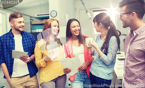 Image of creative team on coffee break talking at office