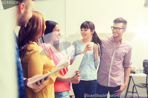 Image of creative team on coffee break talking at office