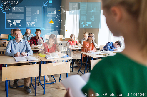 Image of group of students and girl with notebook at school