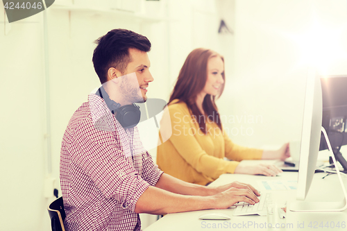 Image of creative team with headphones and computer