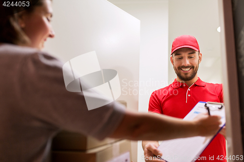 Image of deliveryman and customer with parcel boxes at home