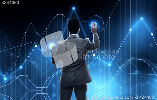 Image of businessman working with virtual chart projection