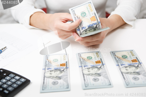 Image of Hands counting money, close up