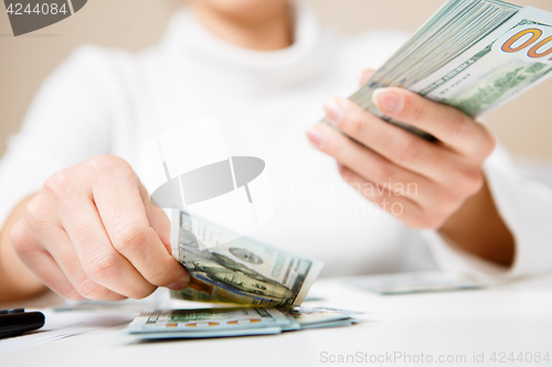 Image of Hands counting money, close up