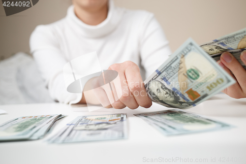 Image of Close up of woman with calculator counting money