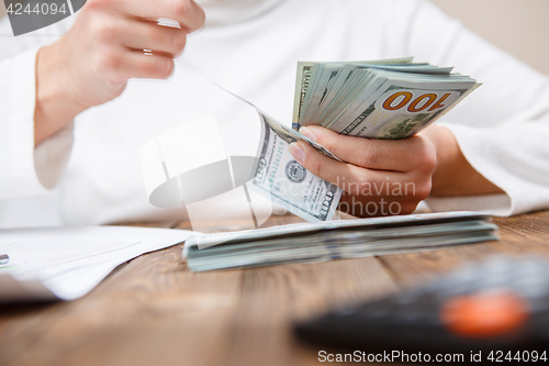 Image of Hands counting money, close up