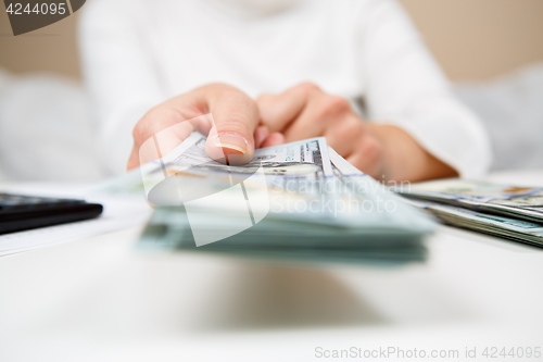 Image of Hands of person proposing money to you - closeup shot