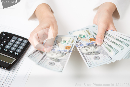 Image of Hands counting money, close up