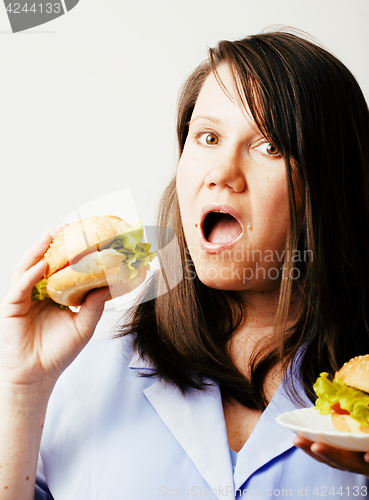 Image of fat white woman having choice between hamburger and salad close 