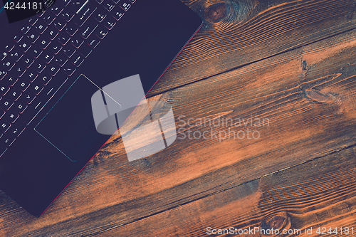 Image of Workspace with laptop on hard wood desk