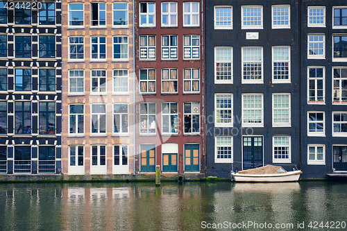 Image of Amsterdam canal Damrak with houses, Netherlands