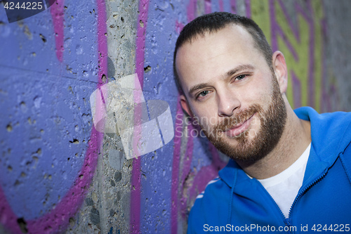 Image of young man at a graffiti wall