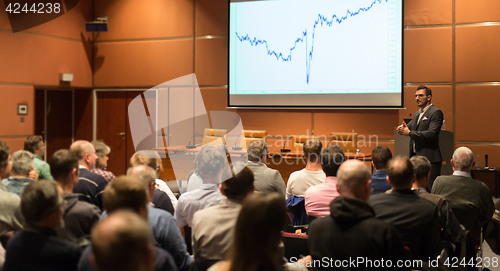 Image of Business speaker giving a talk in conference hall.