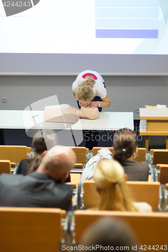 Image of Instructor teaching first aid cardiopulmonary resuscitation workshop.