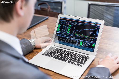 Image of Young businessman working with laptop, man\'s hands on notebook computer.