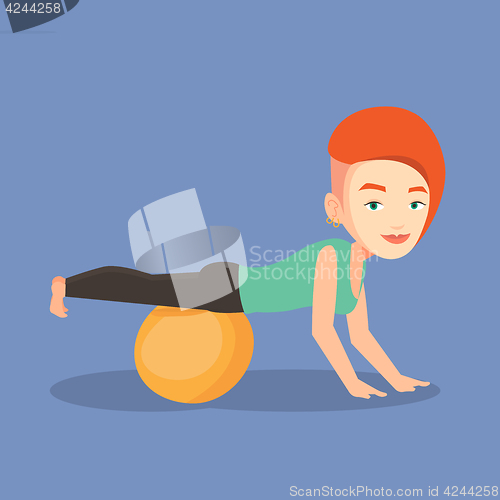 Image of Young woman exercising with fitball.