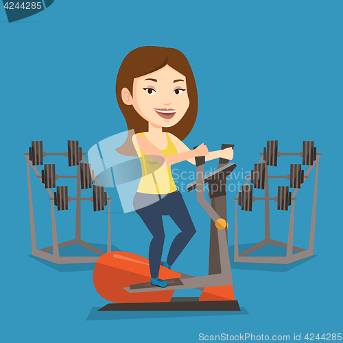 Image of Woman exercising on elliptical trainer.