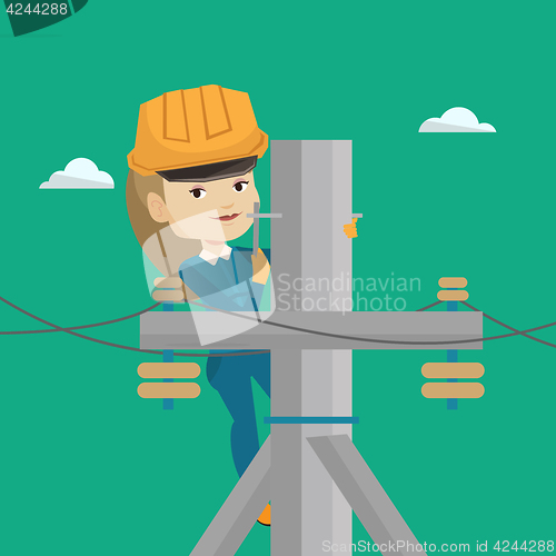 Image of Electrician working on electric power pole.