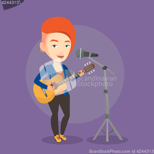 Image of Woman singing in microphone and playing guitar.