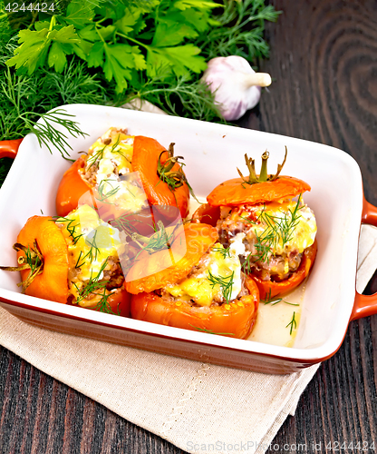 Image of Tomatoes stuffed with rice and meat in brazier on board