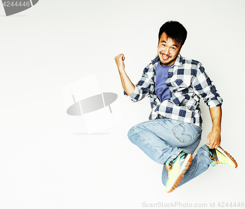 Image of young pretty asian man jumping cheerful against white background