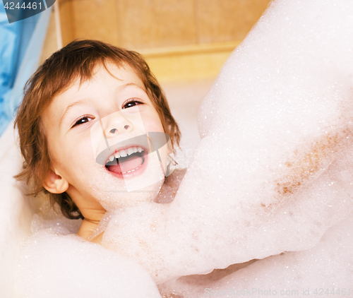 Image of little cute boy in bathroom with bubbles close up smiling, lifes