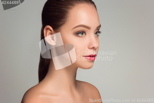 Image of Beautiful woman face portrait close up on blue
