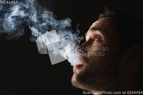 Image of The face of vaping young man