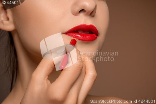 Image of Beautiful female lips with make-up and brush