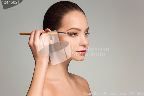 Image of Beautiful female eyes with make-up and brush