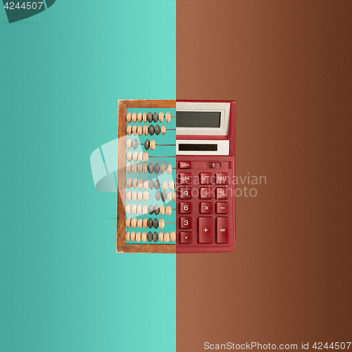 Image of Old wooden abacus and new calculator on colored background.