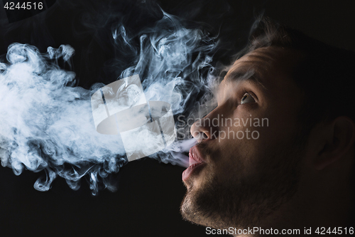 Image of The face of vaping young man