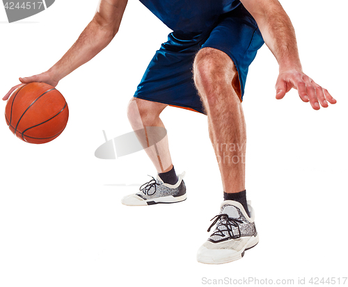 Image of The legs of a basketball player with ball