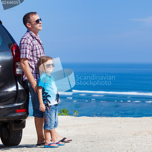 Image of Father and son playing on the beach at the day time. 