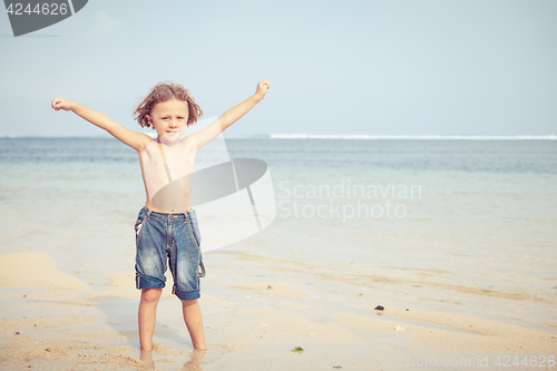 Image of Portrait of little boy standing on the beach